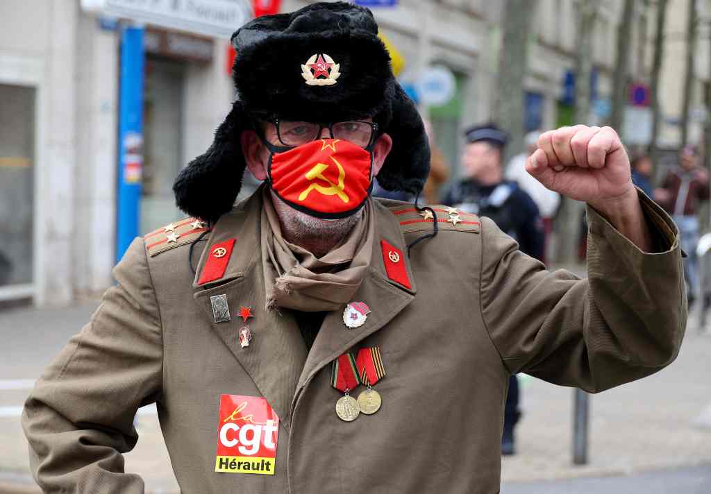 Een demonstrant toont een CGT-poster en een communistisch gezichtsmasker tijdens de 11e werkdag in Montpellier, Frankrijk. 